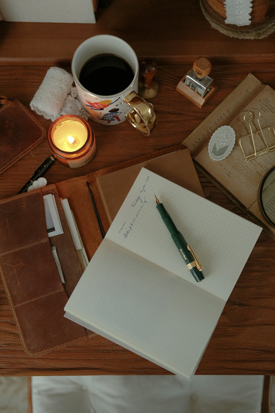 Desk flat-lay with notebook, fountain pen, and coffee.